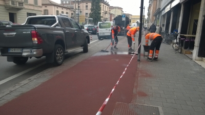 il tracciamento con apposto asfalto rosso della pista ciclabile di via Emilia est